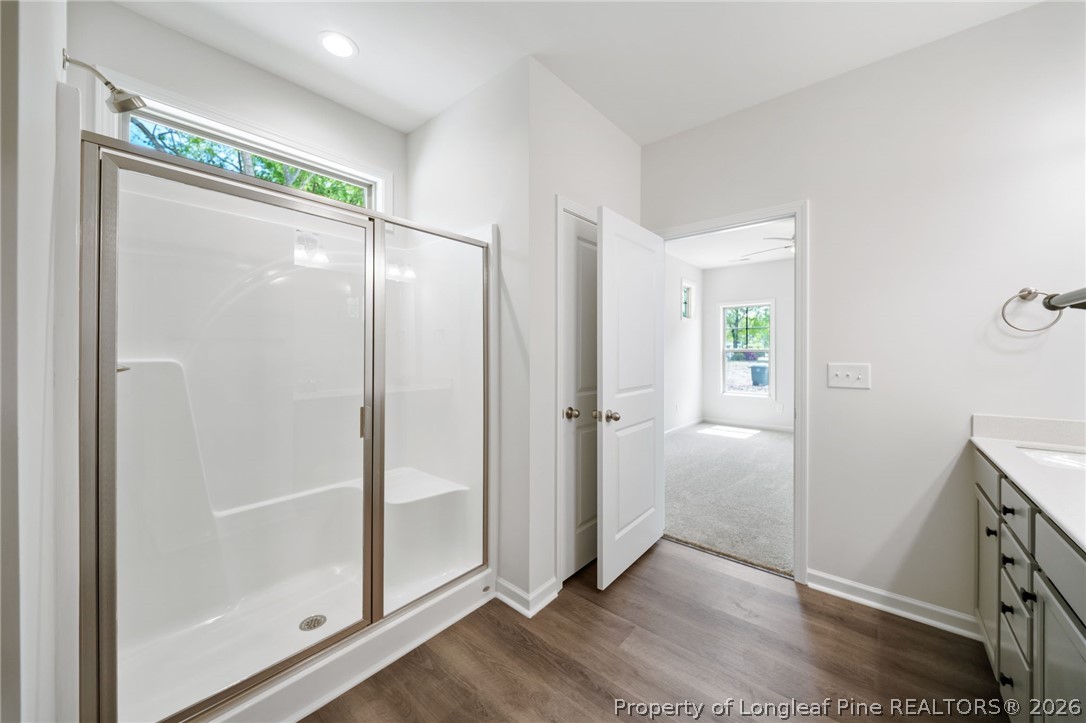 4038 Lofton Street Wade, NC 28395 - Photo 6 of 29 a bathroom with a glass shower door