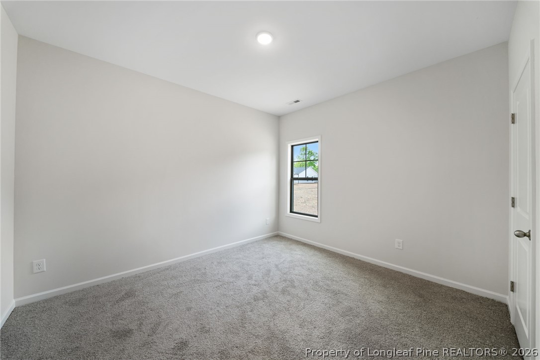 4038 Lofton Street Wade, NC 28395 - Photo 7 of 29 an empty room with windows