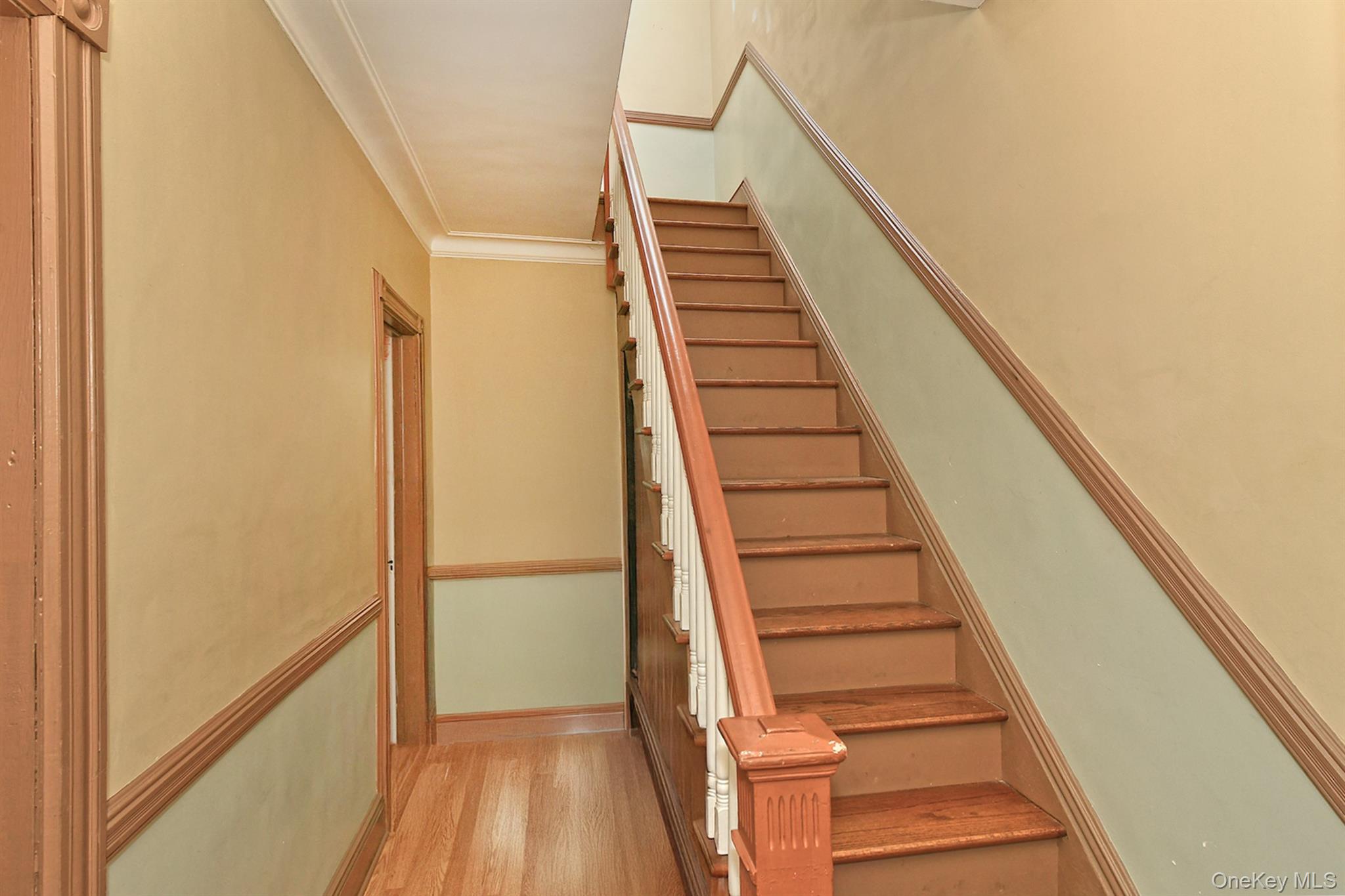 30-94 47th Street Queens, NY 11103 - Photo 13 of 20 Stairway with crown molding and wood finished floors