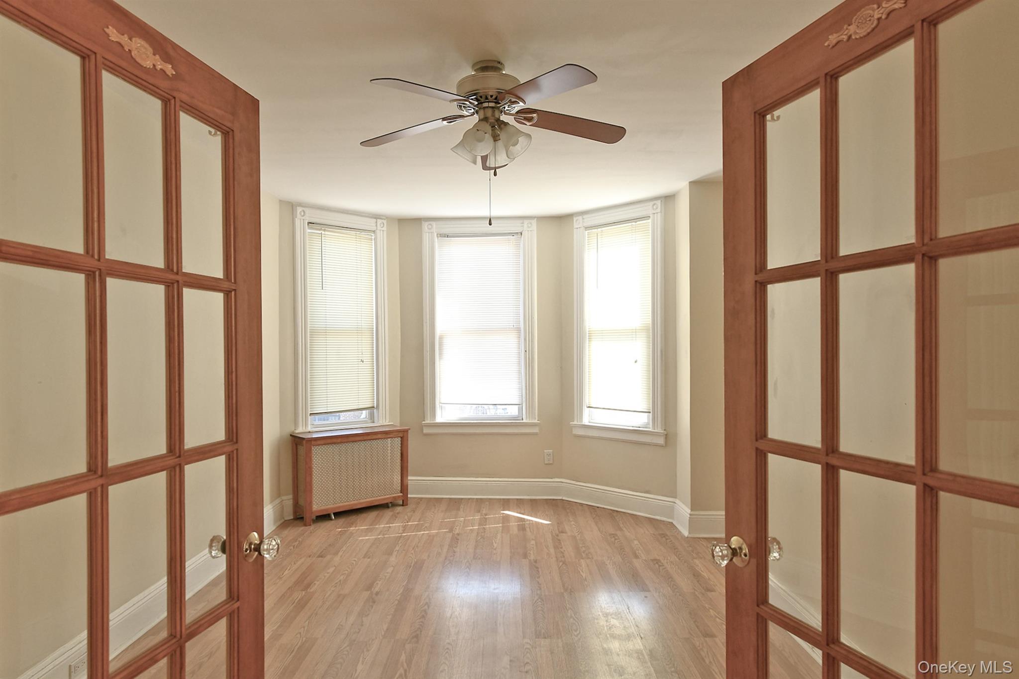30-94 47th Street Queens, NY 11103 - Photo 6 of 20 Large, bright bedroom with beautiful wood entrance doors
