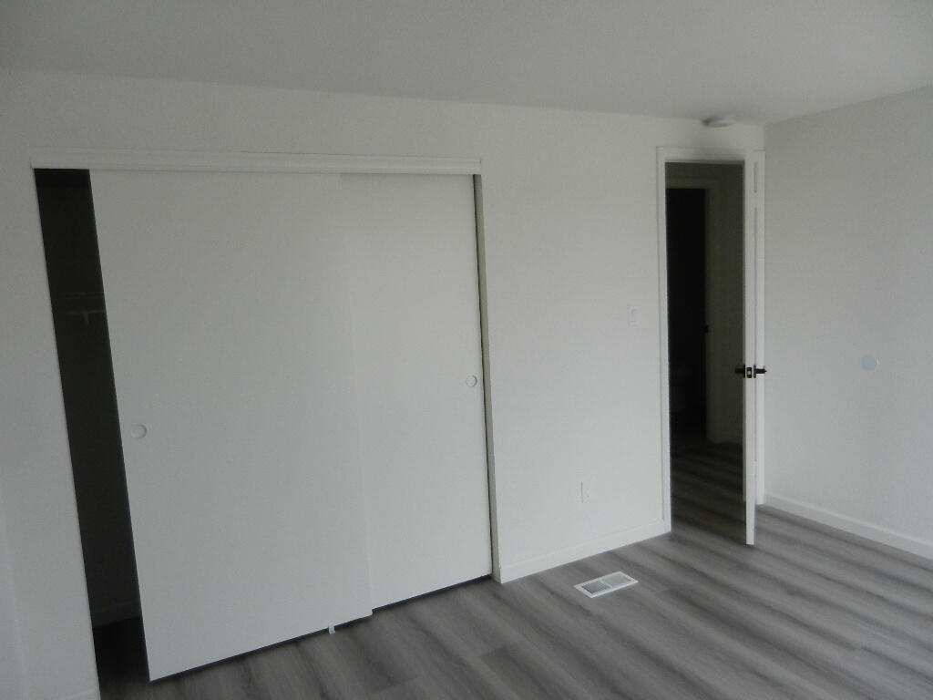 98920 Surfside Avenue Mecca, CA 92254 - Photo 12 of 22 a view of an empty room with wooden floor and closet