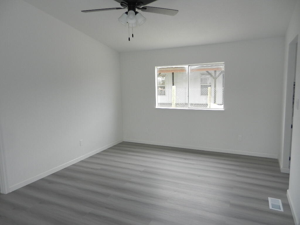 98920 Surfside Avenue Mecca, CA 92254 - Photo 17 of 22 an empty room with a window and a ceiling fan