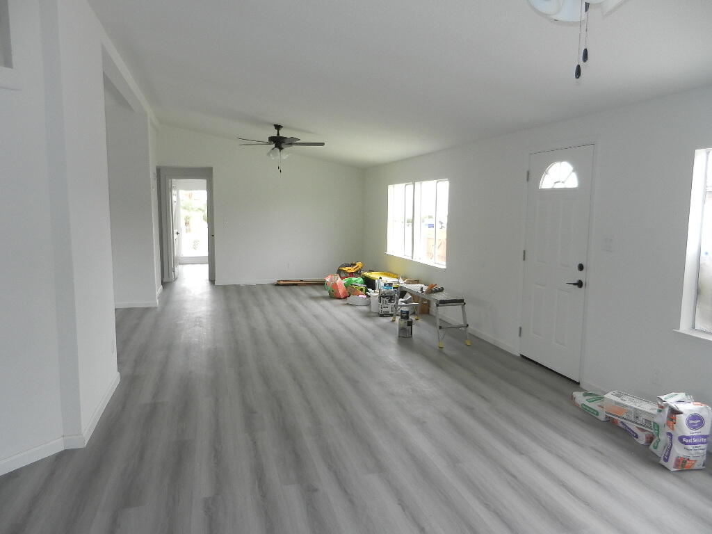 98920 Surfside Avenue Mecca, CA 92254 - Photo 20 of 22 an empty room with wooden floor and windows