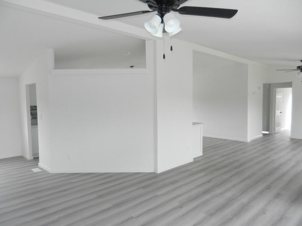 98920 Surfside Avenue Mecca, CA 92254 - Photo 7 of 22 a view of an empty room with wooden floor