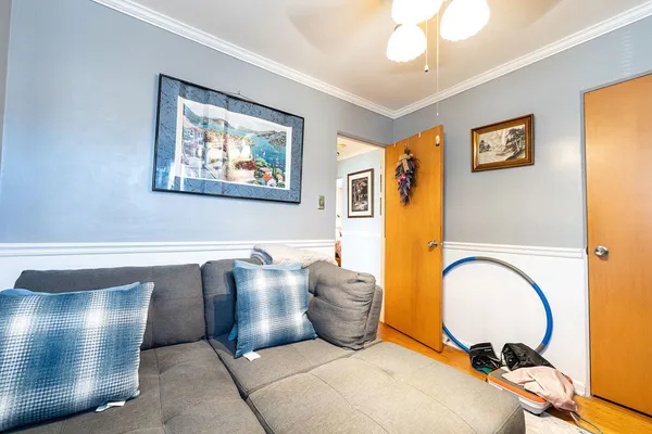 a living room with couch and a painting on the wall