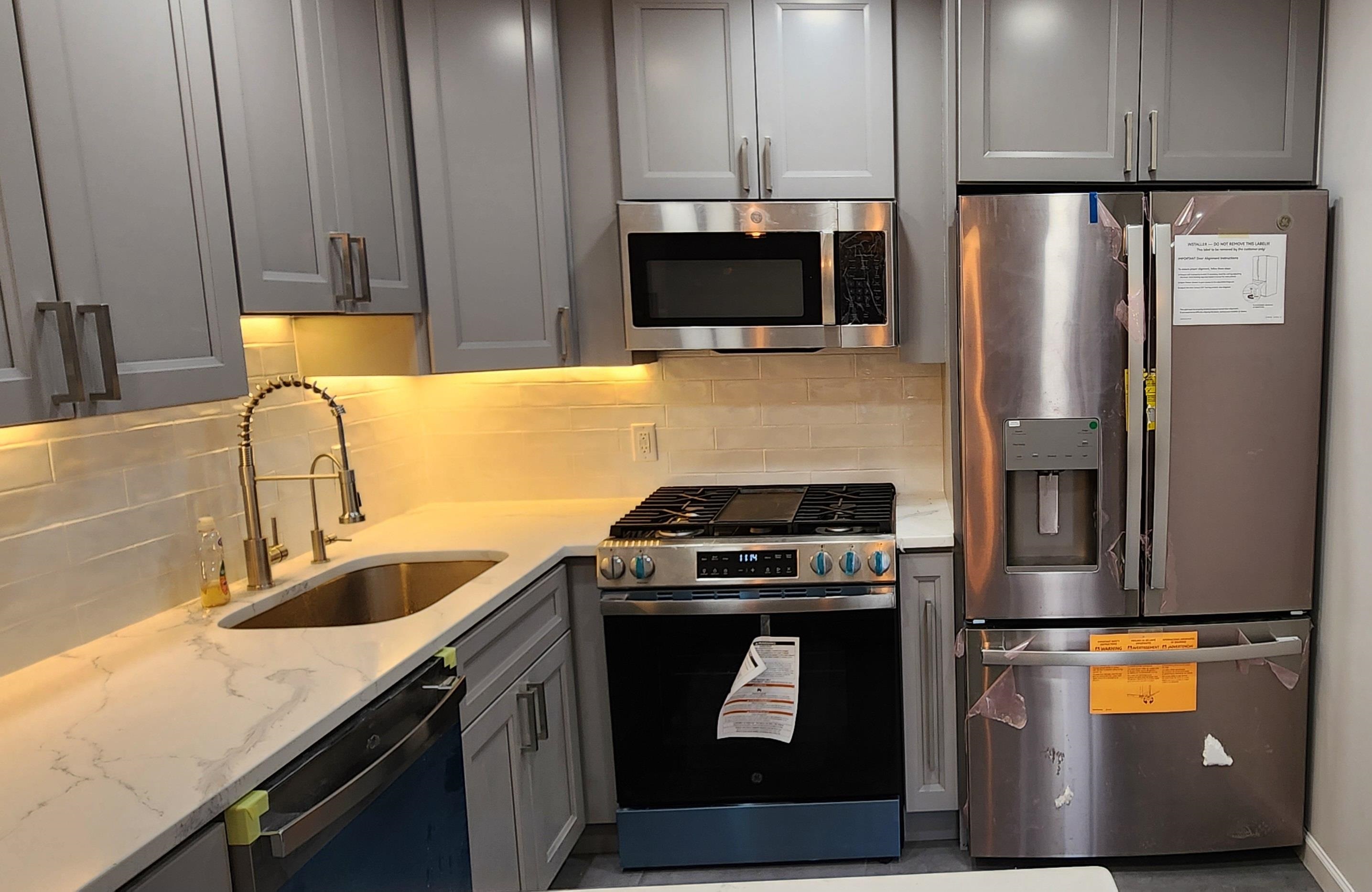 89 Harbor Key, Unit 89 Secaucus, NJ 07094 - Photo 14 of 17 a kitchen with a sink a stove and refrigerator