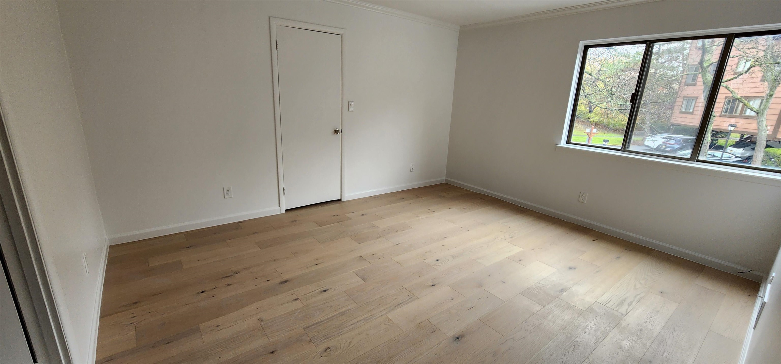 89 Harbor Key, Unit 89 Secaucus, NJ 07094 - Photo 17 of 17 a view of an empty room with wooden floor and a window