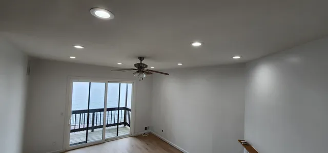 an empty room with windows and closet