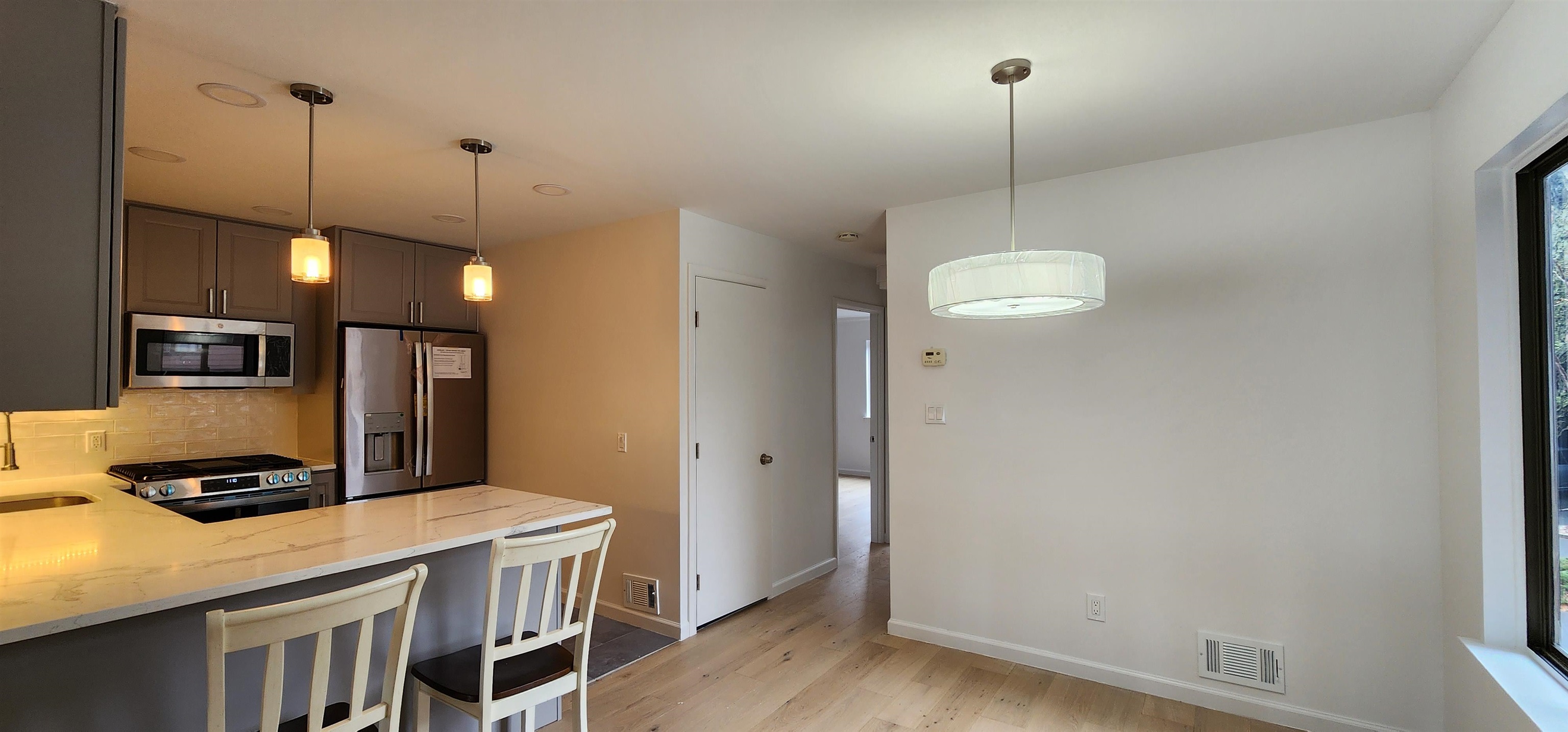 89 Harbor Key, Unit 89 Secaucus, NJ 07094 - Photo 9 of 17 a kitchen with a refrigerator a stove and a wooden floor