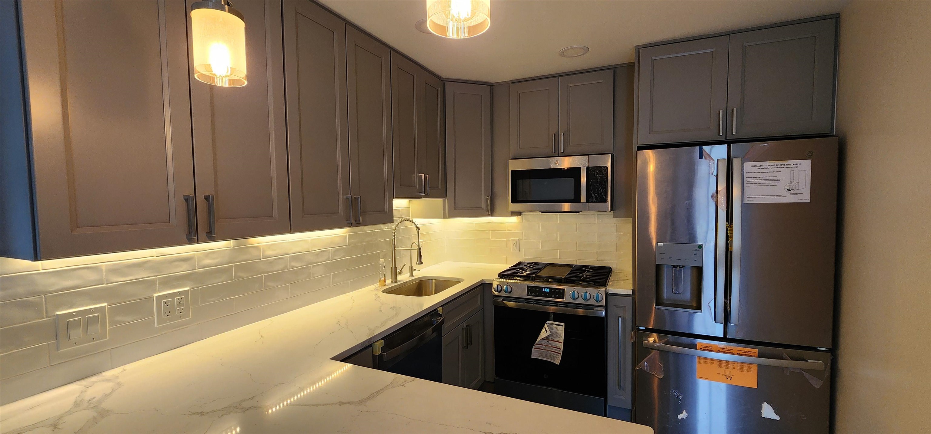 89 Harbor Key, Unit 89 Secaucus, NJ 07094 - Photo 10 of 17 a kitchen with granite countertop a refrigerator stove and microwave