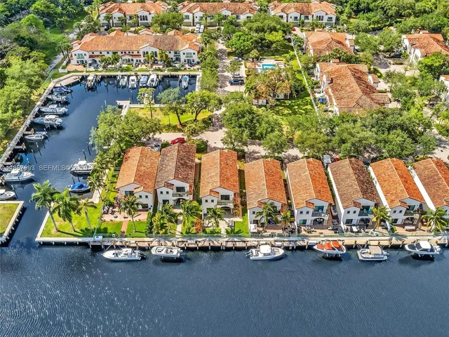 an aerial view of residential houses with outdoor space and parking