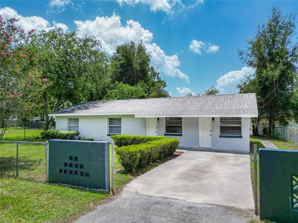 1910 Southwest 2nd Street Ocala, FL 34471 - Photo 1 of 1 a front view of a house with a garden