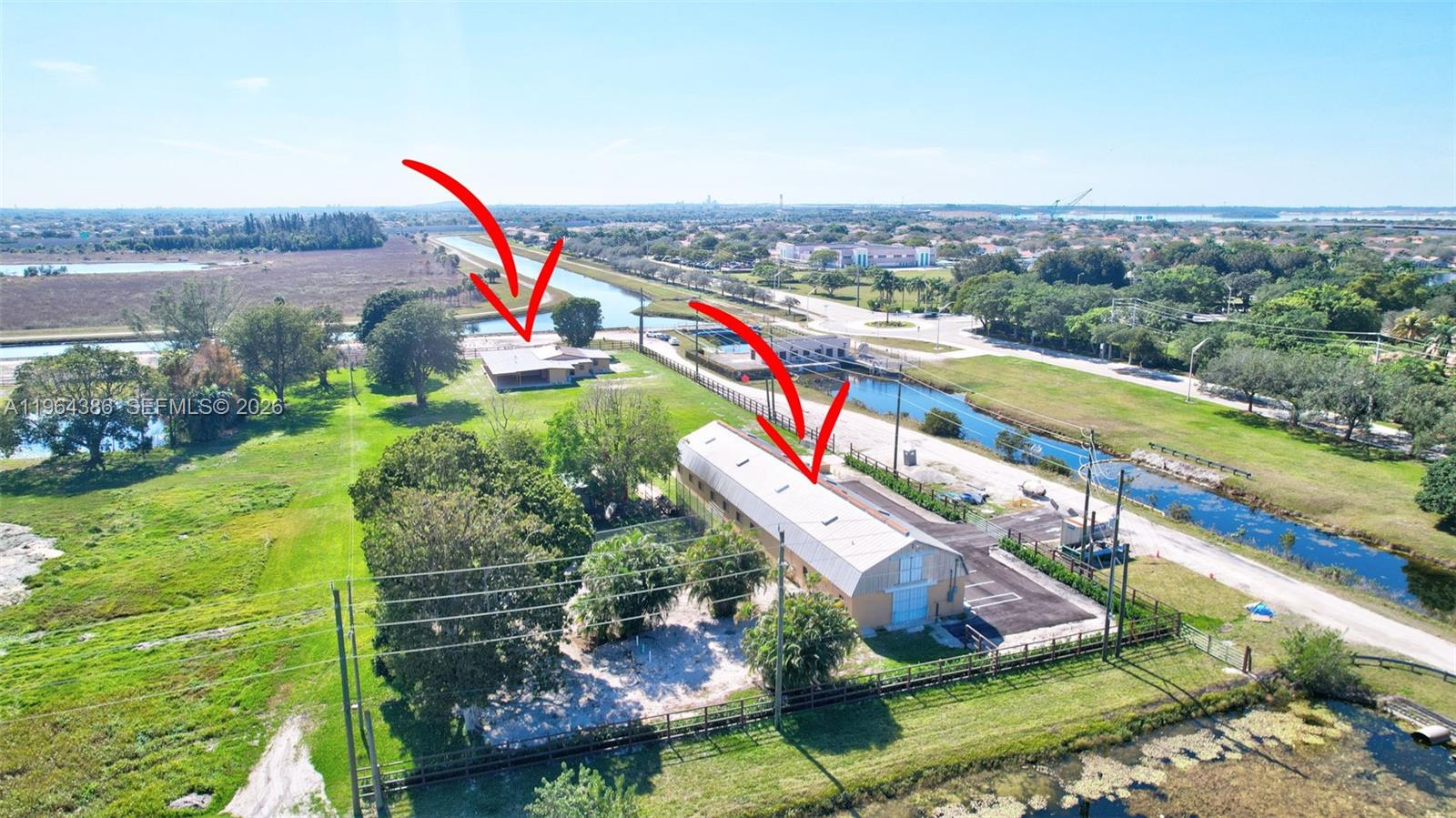 14799 Southwest 48th Court Miramar, FL 33027 - Photo 20 of 34 an aerial view of a house with a yard and lake view