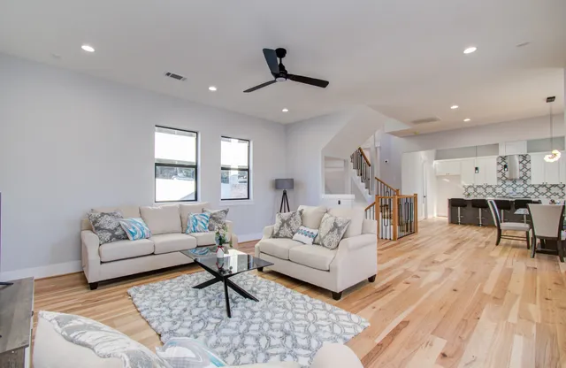 a living room with furniture and wooden floor