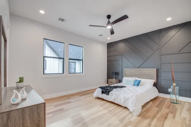 a bedroom with a large bed and a dresser