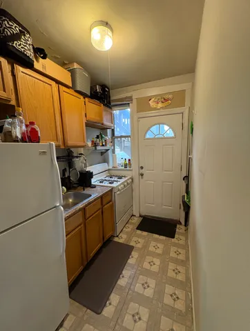a kitchen with sink cabinets and appliances
