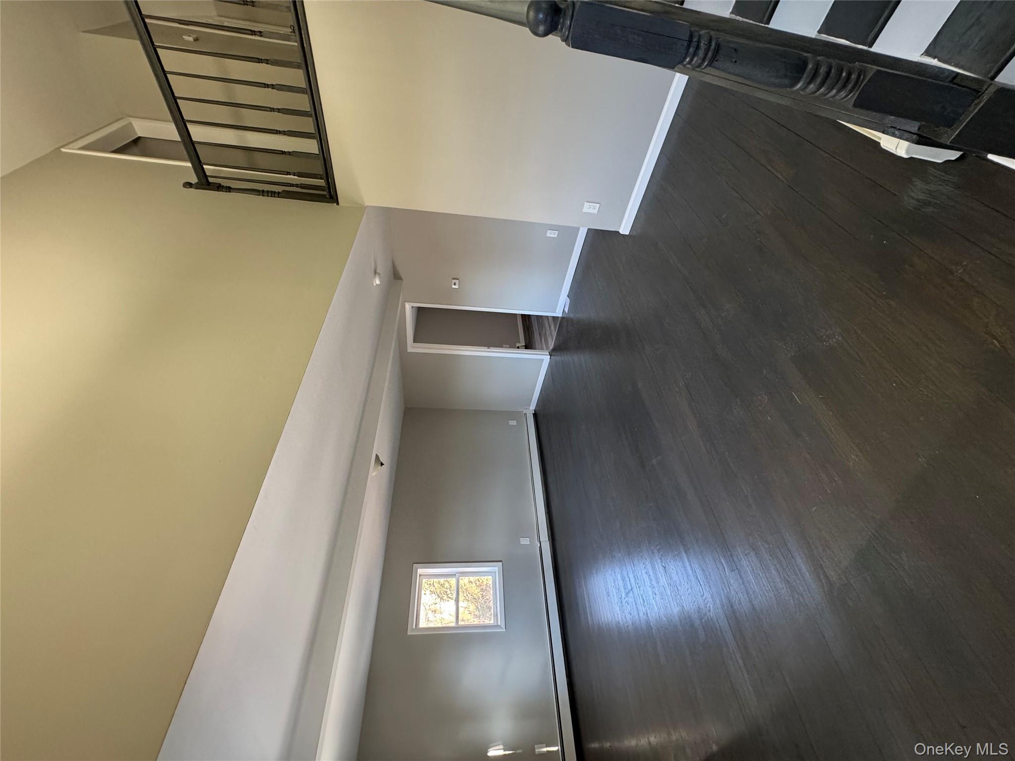 654 Milltown Road Danbury, CT 06811 - Photo 14 of 33 a view of an empty room with wooden floor and a window