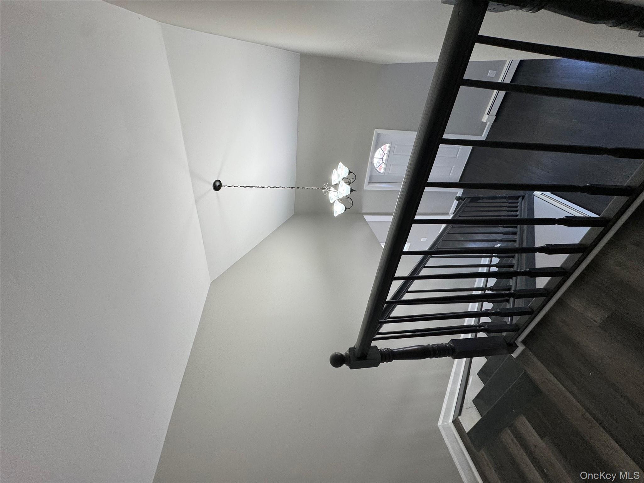 654 Milltown Road Danbury, CT 06811 - Photo 23 of 33 a view of a hallway with wooden floor and chandelier