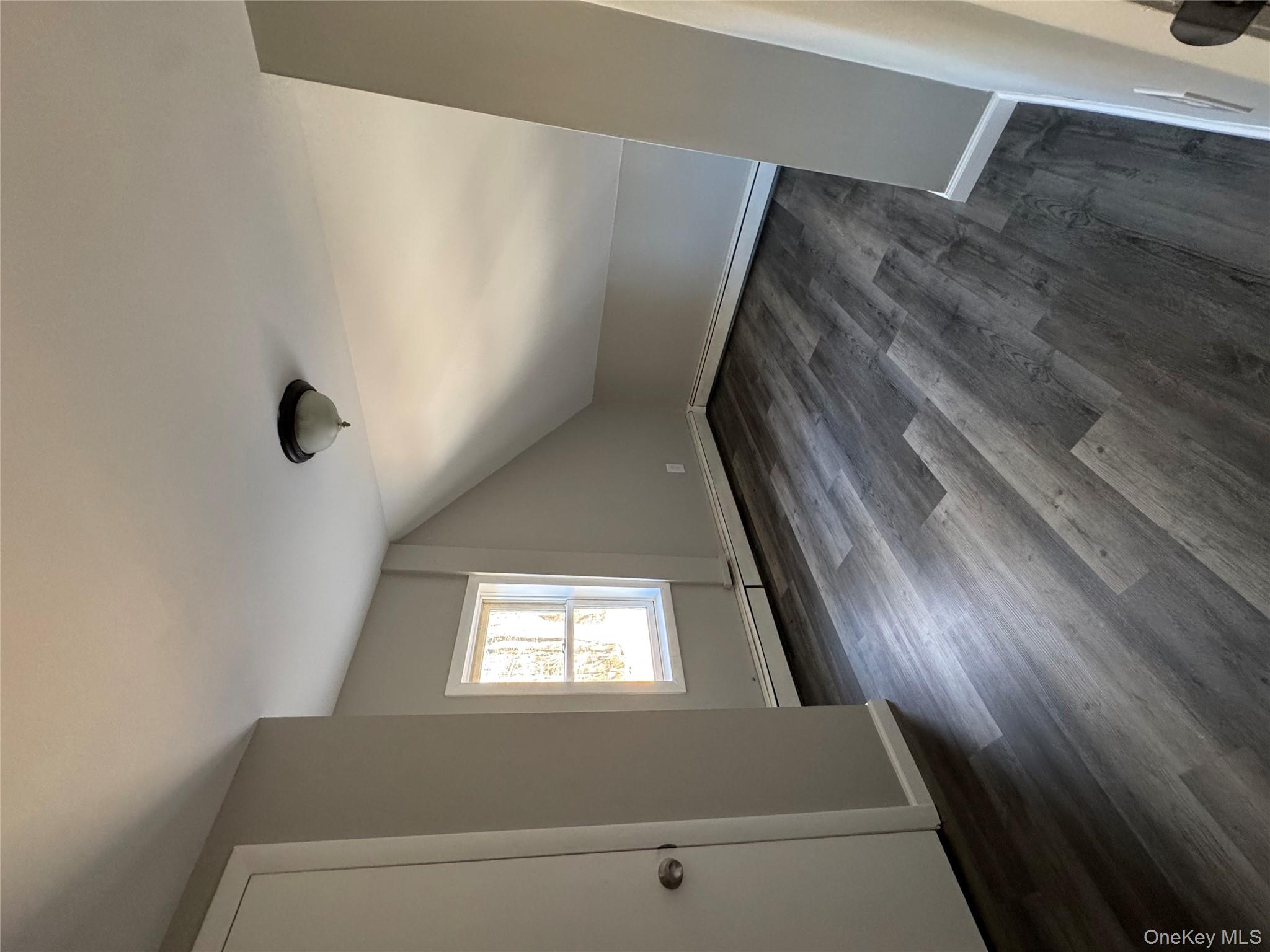 654 Milltown Road Danbury, CT 06811 - Photo 24 of 33 an empty room with wooden floor and windows