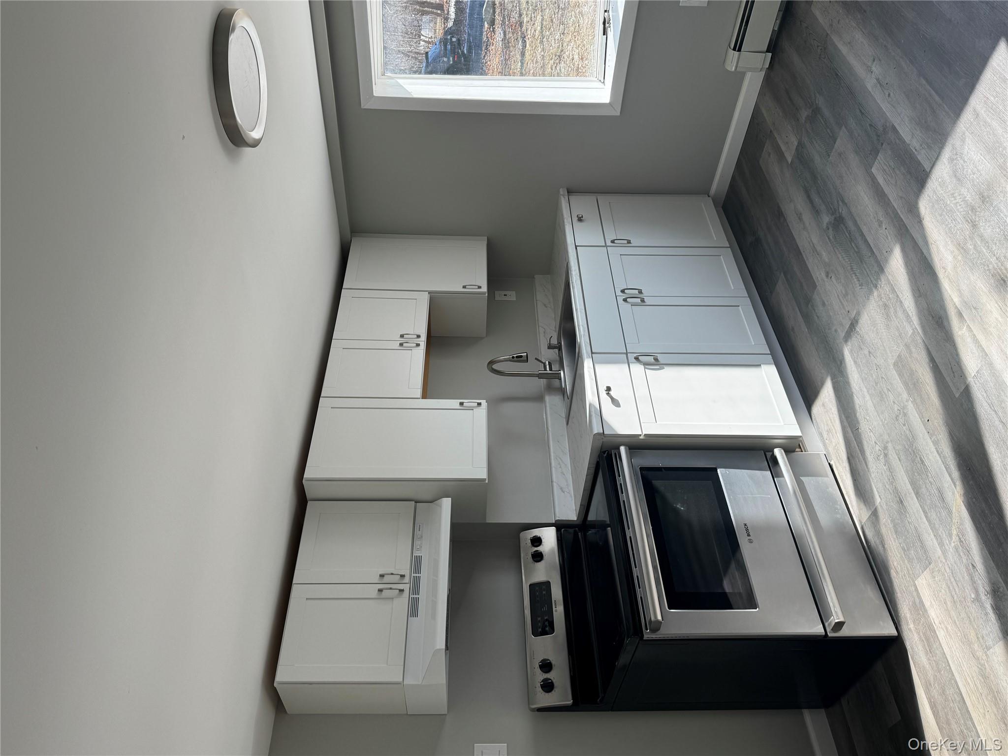 654 Milltown Road Danbury, CT 06811 - Photo 31 of 33 a kitchen with granite countertop white cabinets and appliances