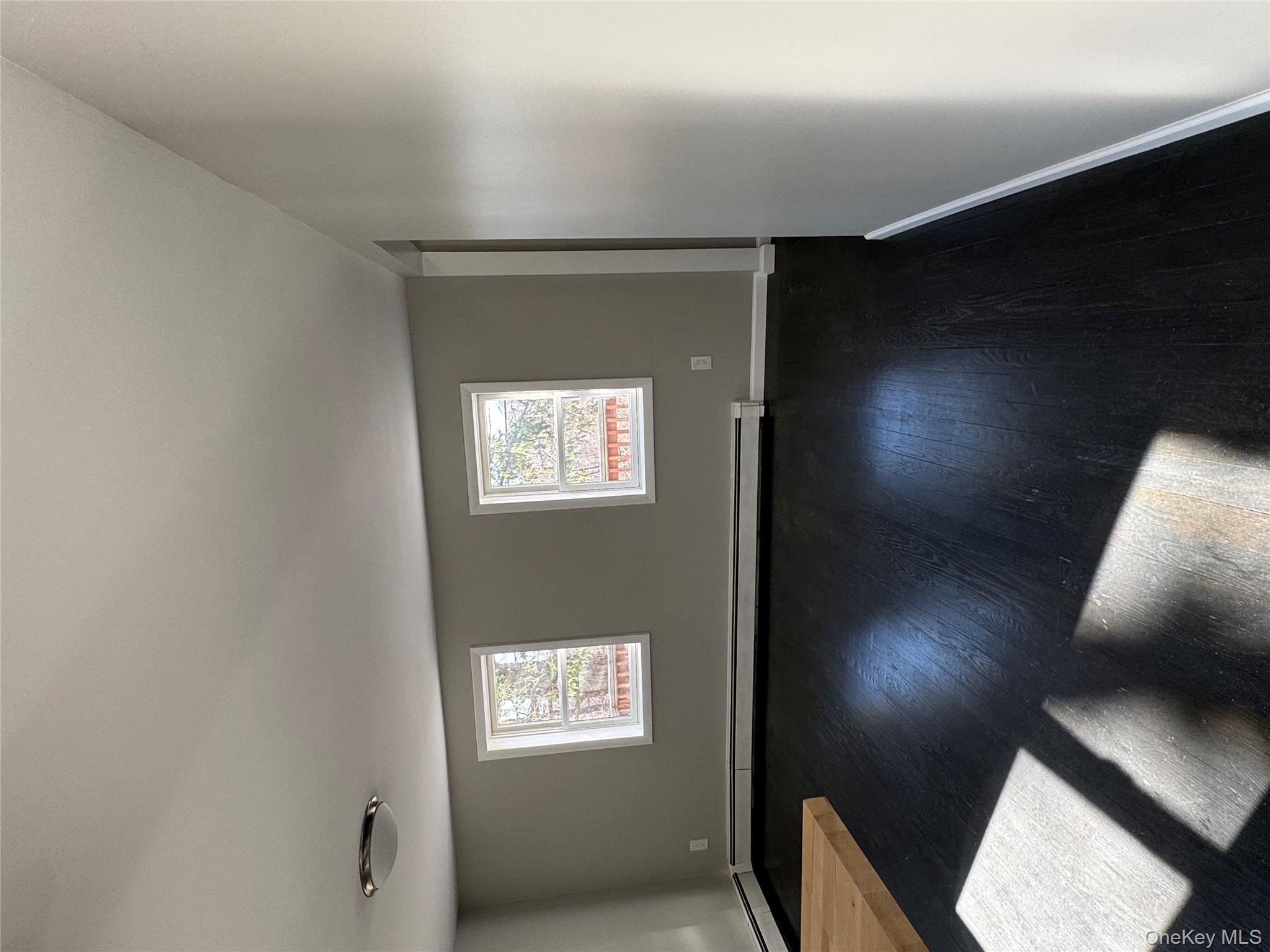 654 Milltown Road Danbury, CT 06811 - Photo 32 of 33 an empty room with wooden floor and windows