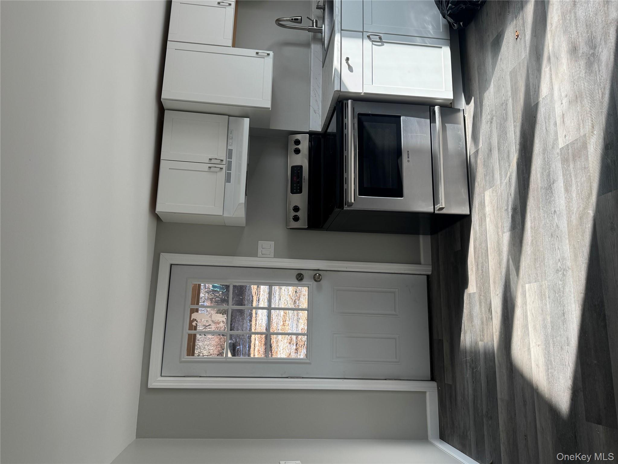 654 Milltown Road Danbury, CT 06811 - Photo 4 of 33 a kitchen with white cabinets and appliances