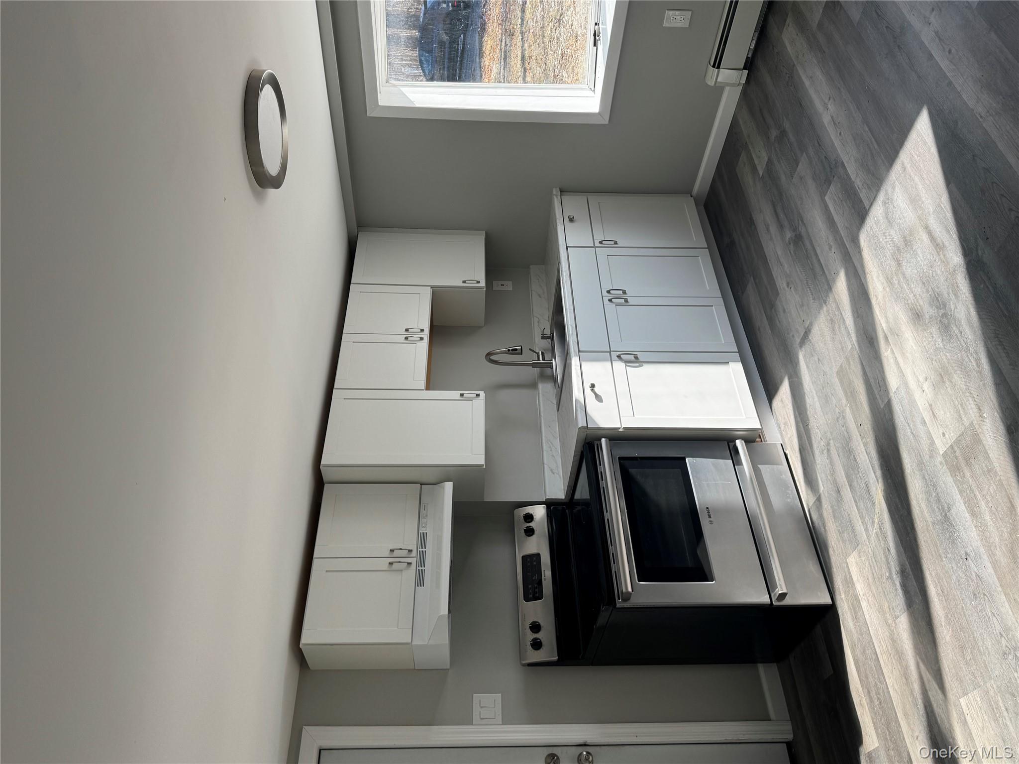 654 Milltown Road Danbury, CT 06811 - Photo 5 of 33 a kitchen with granite countertop a stove cabinets and wooden floor