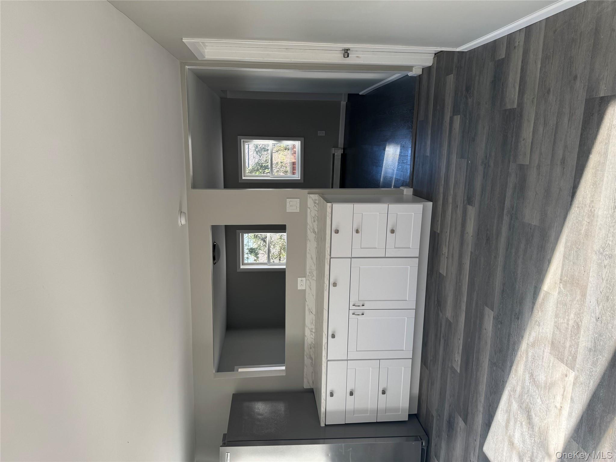 654 Milltown Road Danbury, CT 06811 - Photo 7 of 33 a view of an empty room with wooden floor and a window