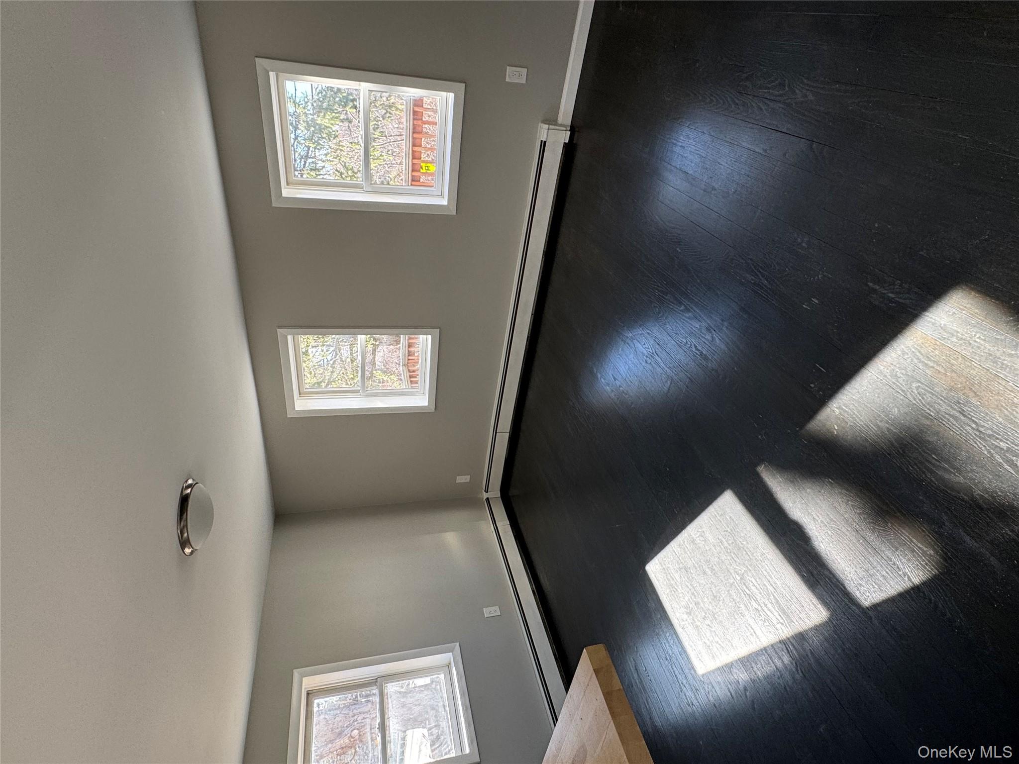 654 Milltown Road Danbury, CT 06811 - Photo 9 of 33 a view of an empty room with windows