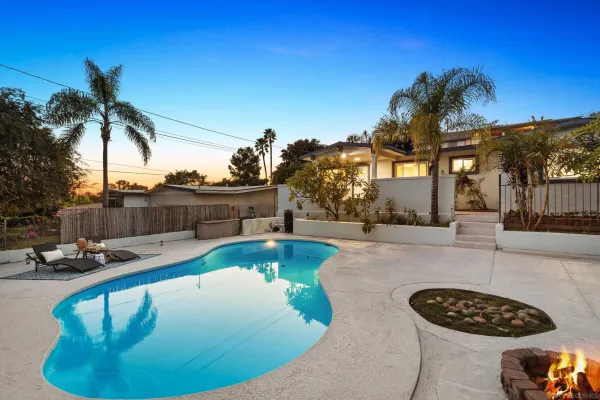 a view of a swimming pool with outdoor seating