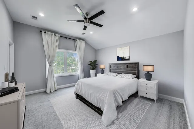 a bedroom with a large bed and a large window