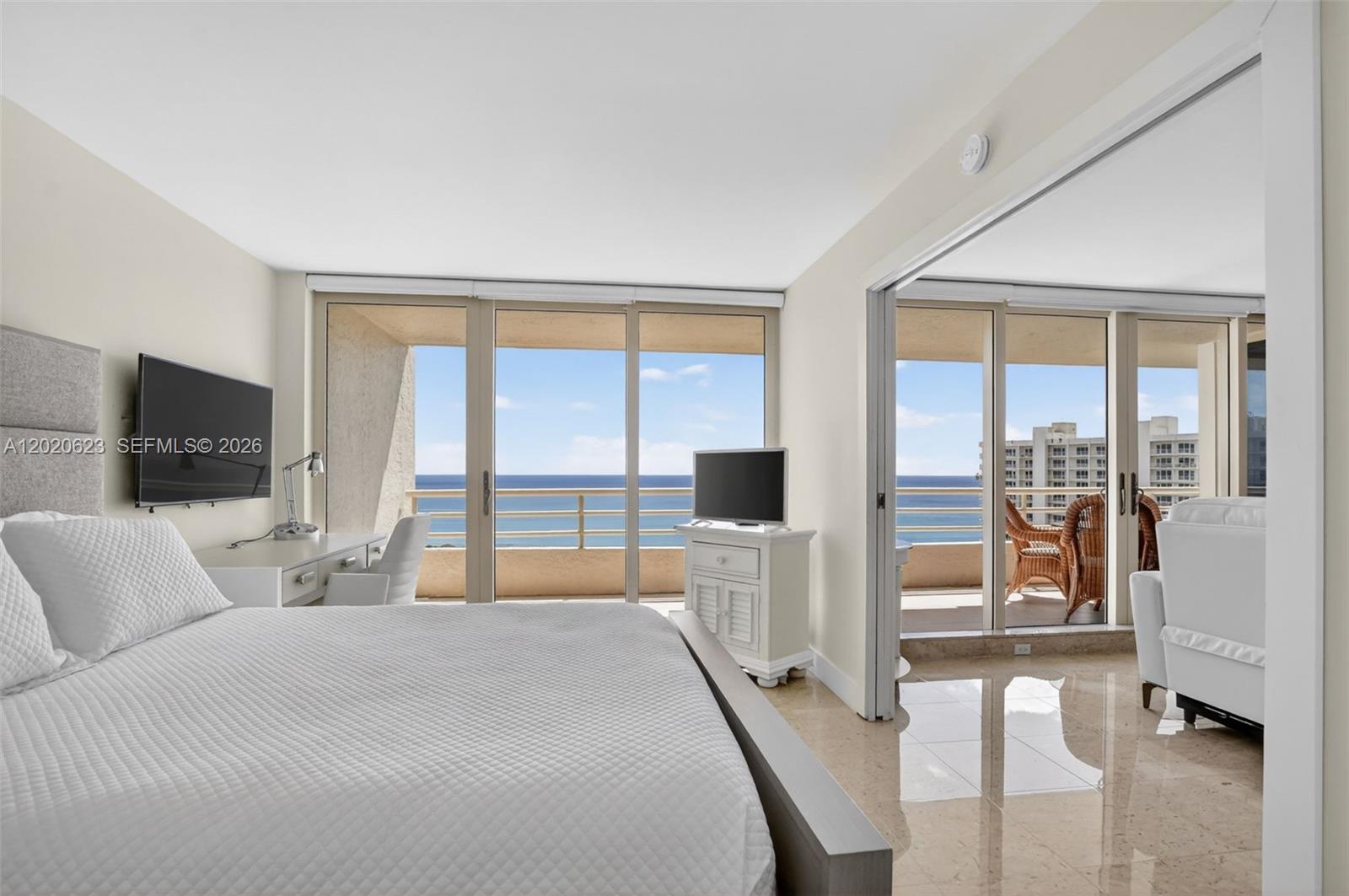 4101 North Ocean Boulevard, Unit 1605 Boca Raton, FL 33431 - Photo 17 of 35 a bedroom with a bed and a flat tv screen next to a window