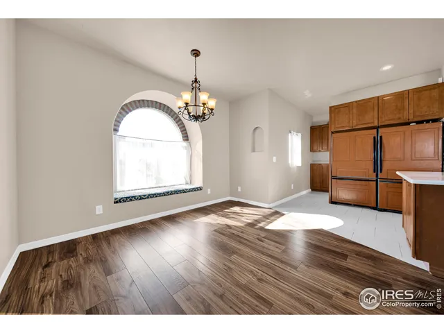 a view interior of a house with wooden floor windows and a chandelier