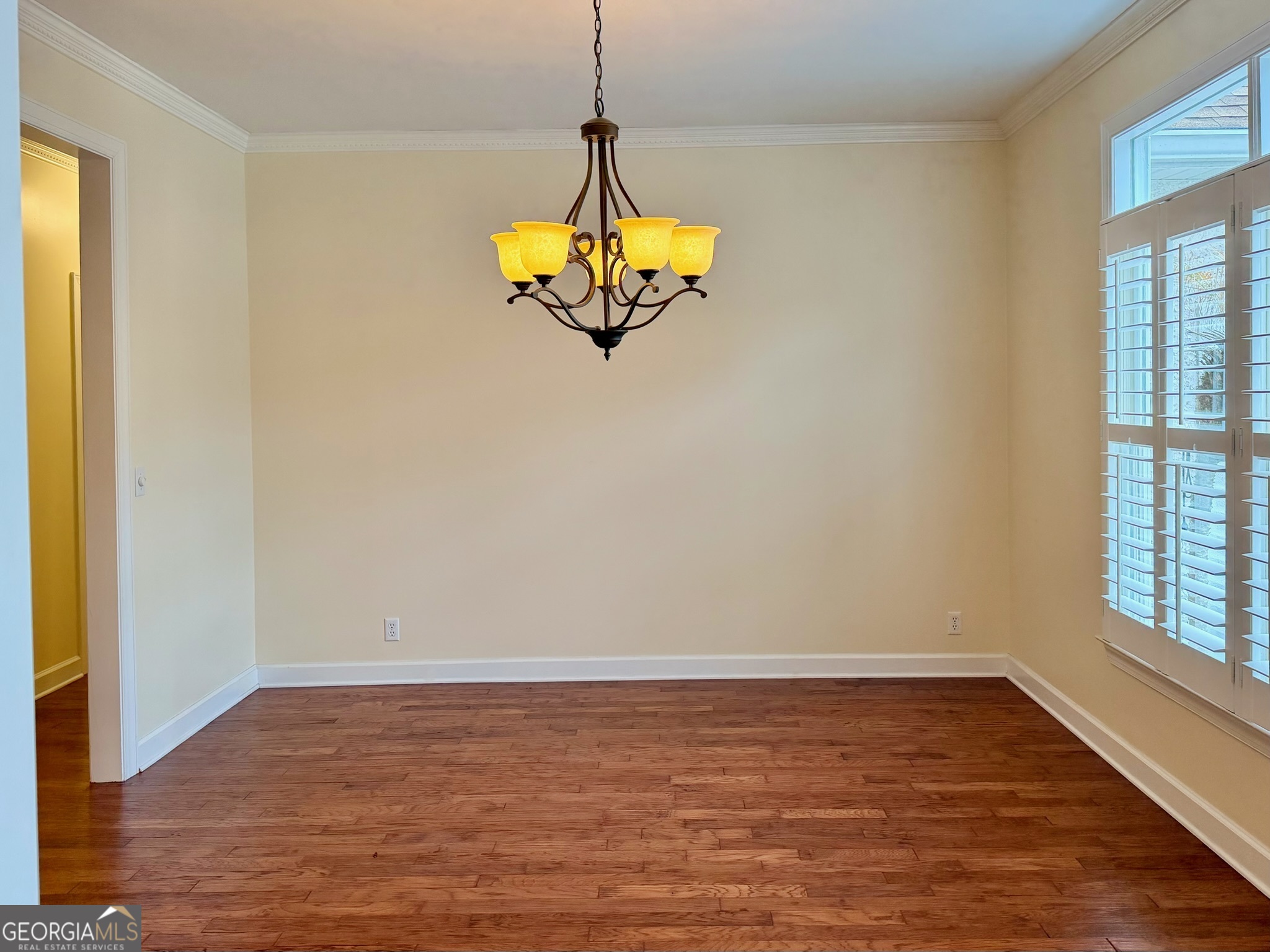 317 Commons Road St. Simons, GA 31522 - Photo 11 of 44 a view of a room with wooden floor and a window