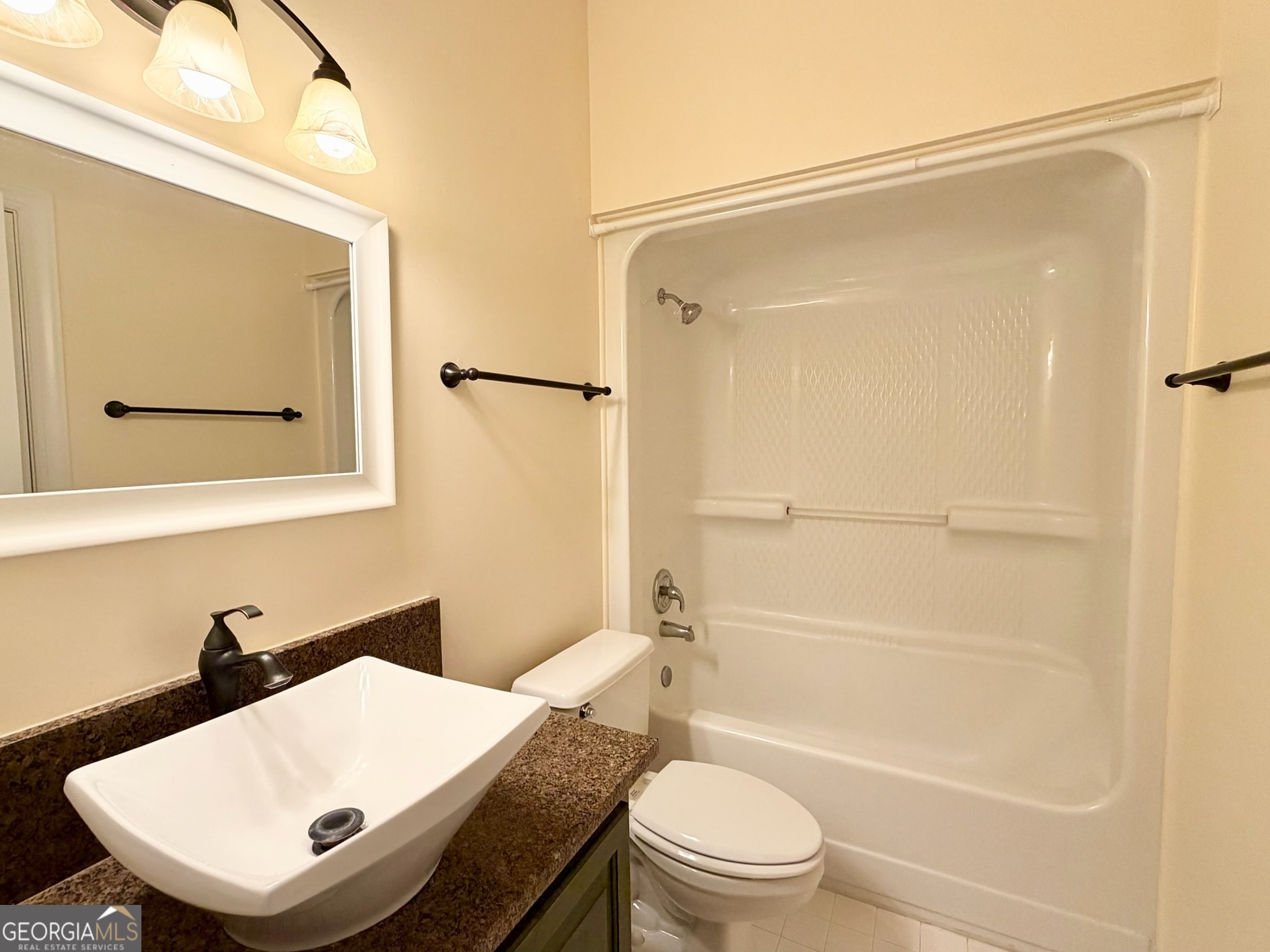 317 Commons Road St. Simons, GA 31522 - Photo 21 of 44 a bathroom with a sink toilet and shower