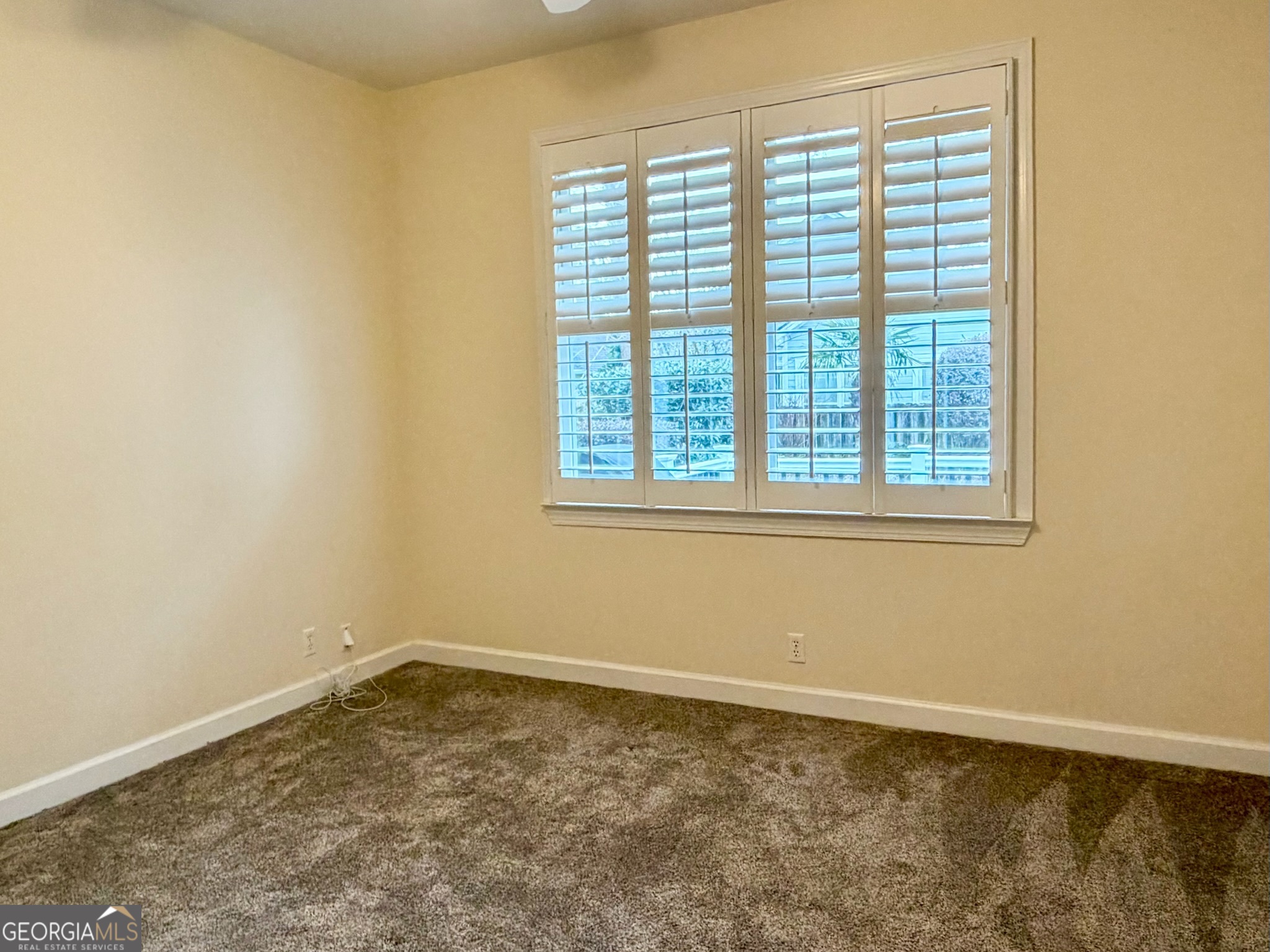 317 Commons Road St. Simons, GA 31522 - Photo 22 of 44 an empty room with a window