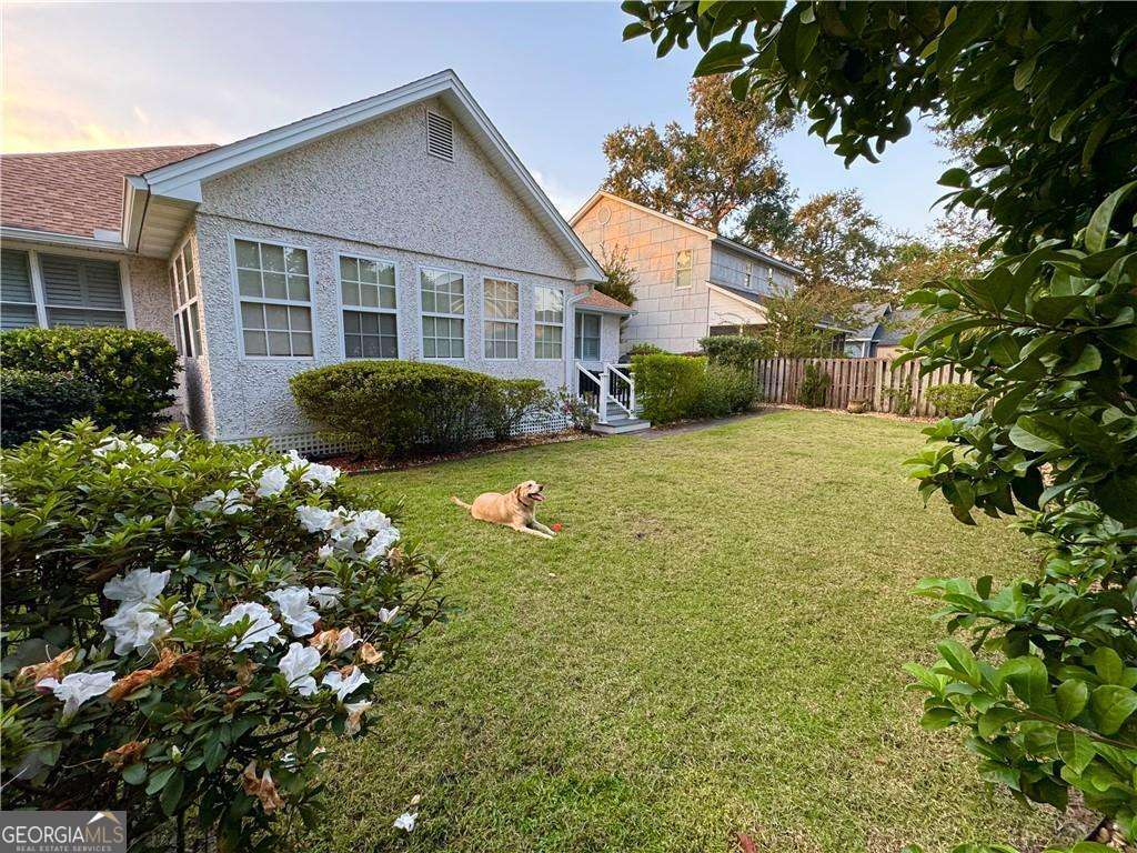 317 Commons Road St. Simons, GA 31522 - Photo 34 of 44 a view of a house with a garden