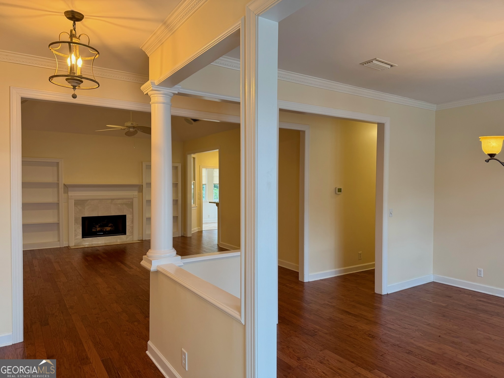 317 Commons Road St. Simons, GA 31522 - Photo 4 of 44 a view of a hallway with wooden floor and a fireplace