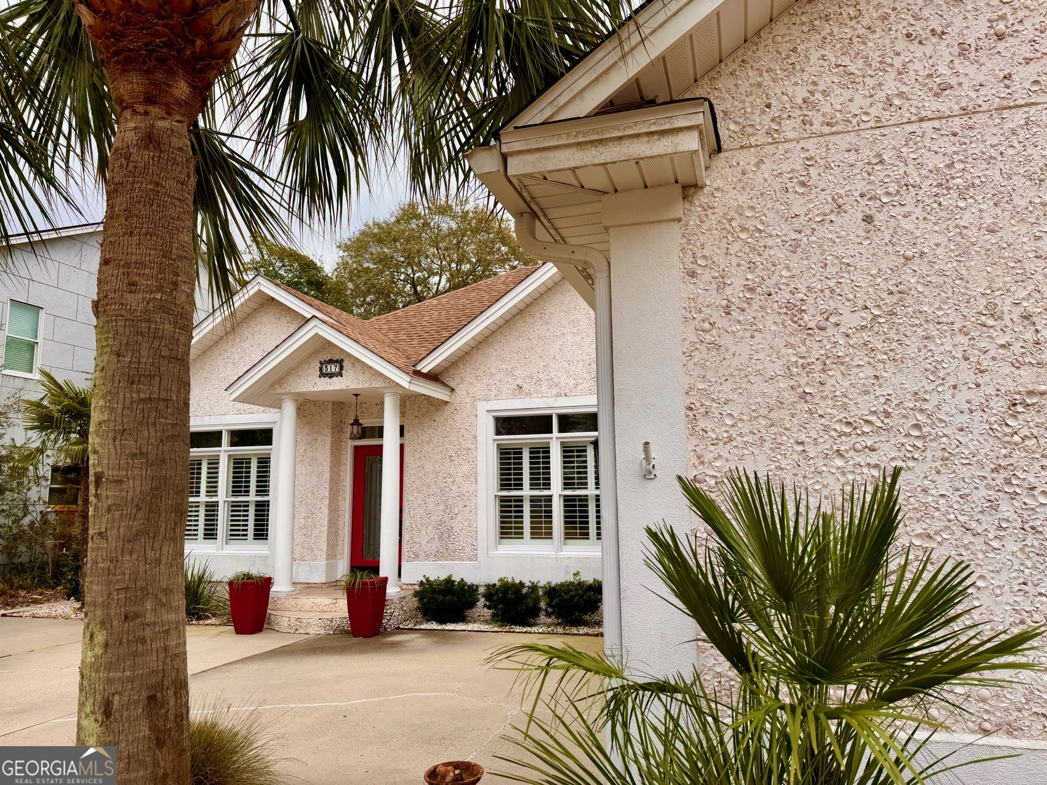 317 Commons Road St. Simons, GA 31522 - Photo 42 of 44 a view of a house with a small yard and plants
