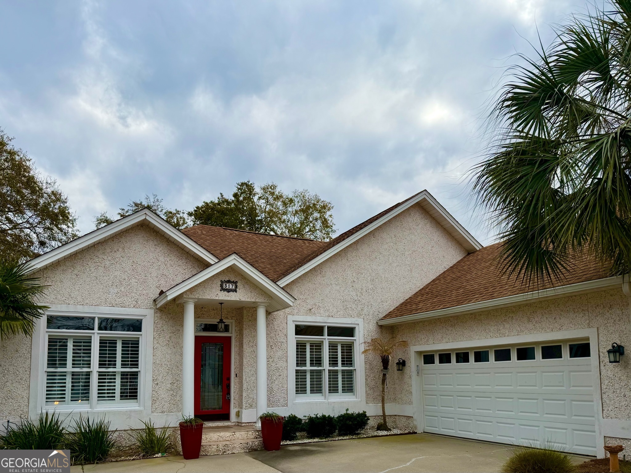 317 Commons Road St. Simons, GA 31522 - Photo 43 of 44 a front view of a house with a yard