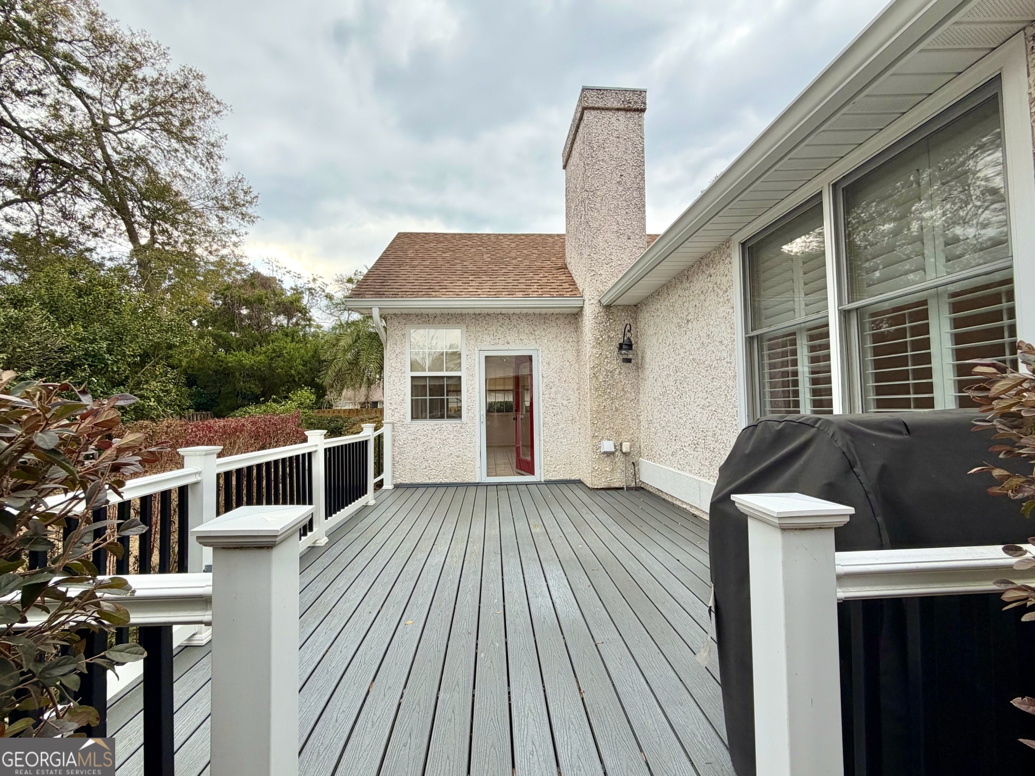 317 Commons Road St. Simons, GA 31522 - Photo 44 of 44 a front view of a house with balcony and wooden floor