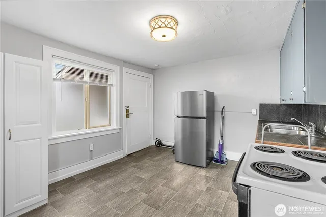 a bathroom with a tub shower sink and mirror