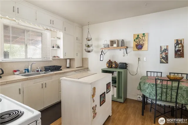 a kitchen with a stove a sink and a refrigerator