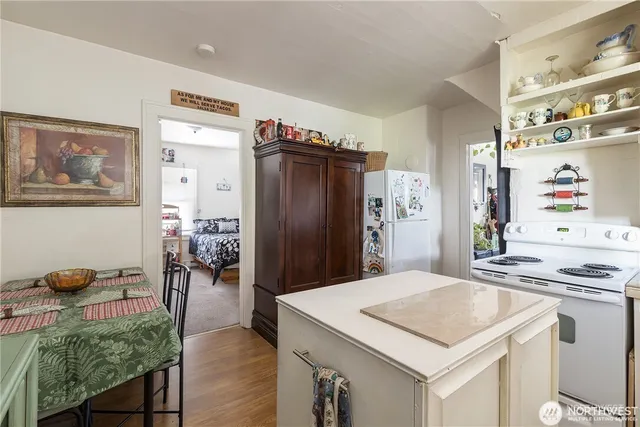 a bathroom with a granite countertop toilet a sink a shower and a window