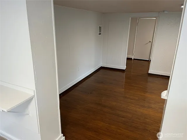 an empty room with wooden floor