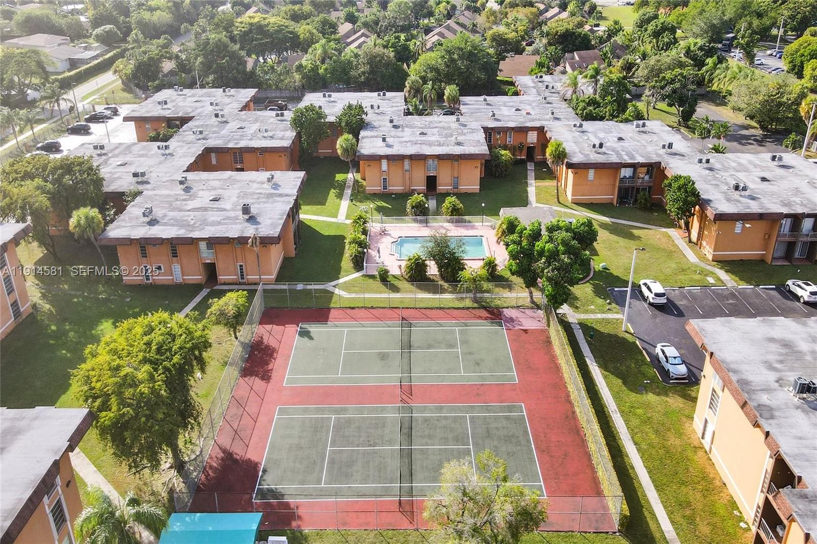 9459 Southwest 76th Street, Unit R7 Miami, FL 33173 - Photo 20 of 21 a aerial view of a multi story building with yard