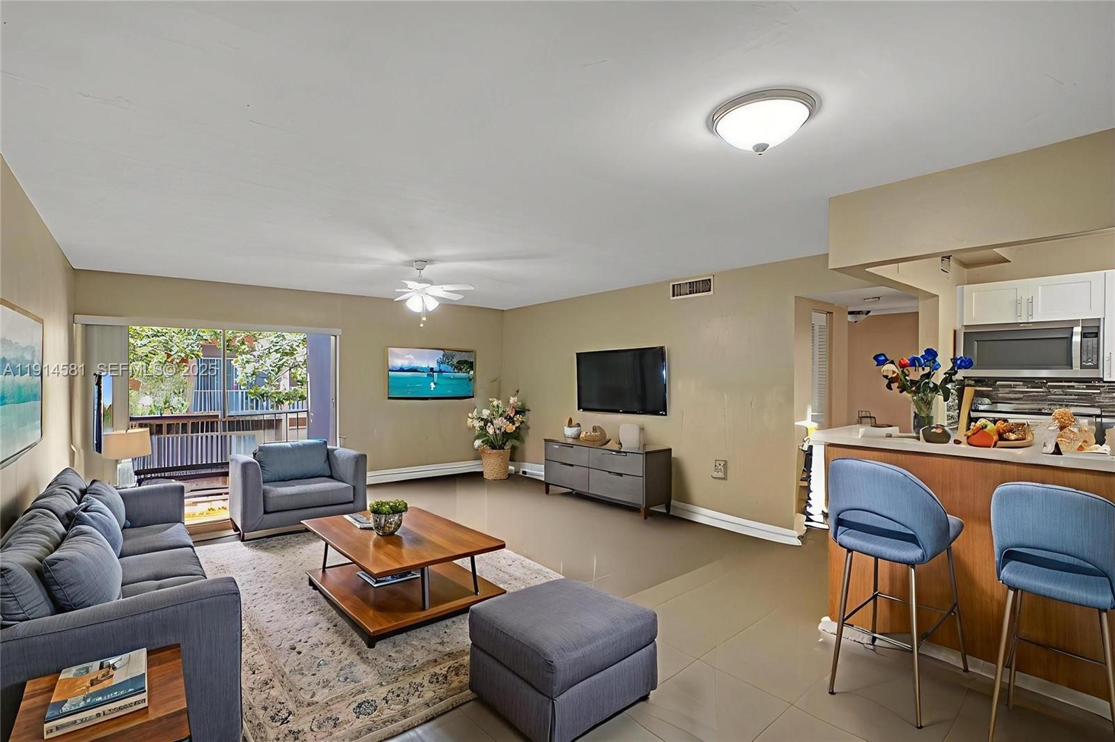 9459 Southwest 76th Street, Unit R7 Miami, FL 33173 - Photo 2 of 21 a living room with furniture and a flat screen tv