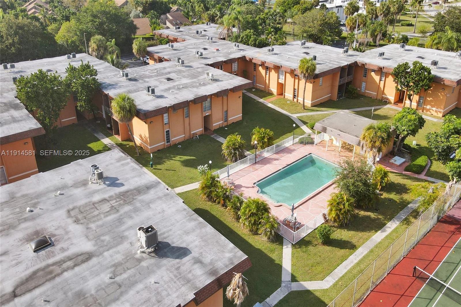 9459 Southwest 76th Street, Unit R7 Miami, FL 33173 - Photo 21 of 21 an aerial view of a house with a yard