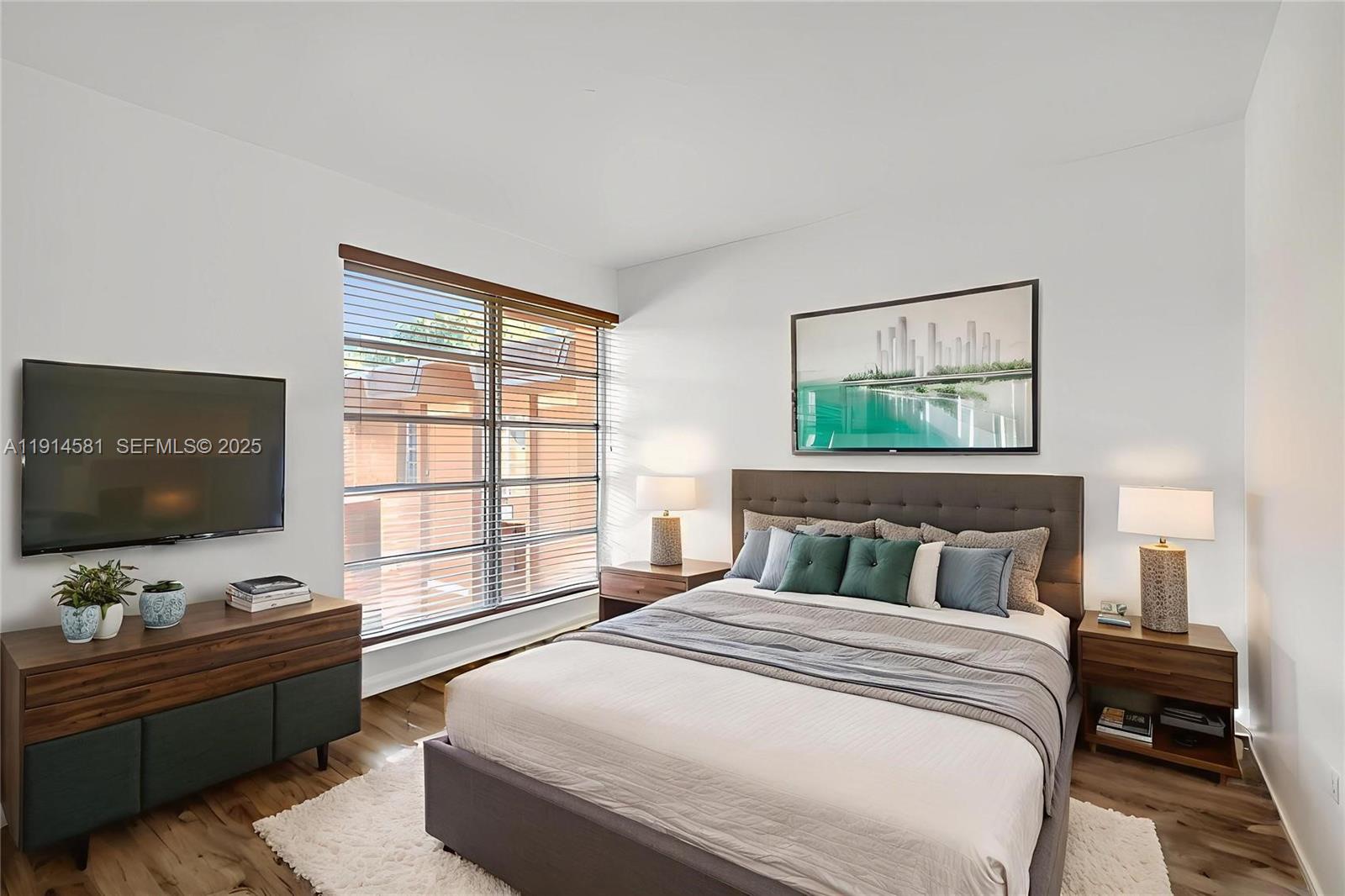 9459 Southwest 76th Street, Unit R7 Miami, FL 33173 - Photo 3 of 21 a bedroom with a bed and a flat screen tv