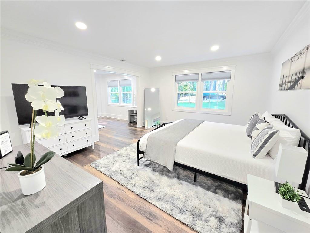 2900 Orchard Road Southwest Conyers, GA 30094 - Photo 14 of 63 a spacious bedroom with a bed a couch and potted plant on the counter